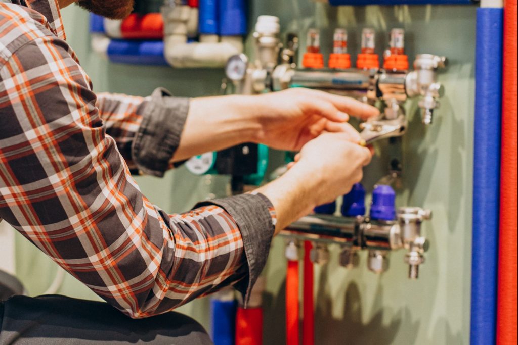 Young engineer adjusting autonomous heating